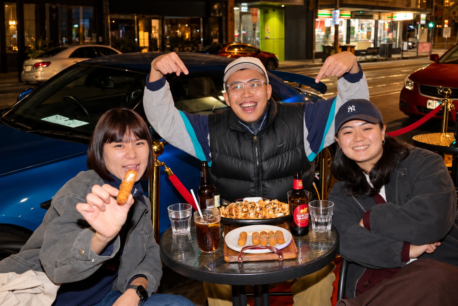 Three guests sharing food at Illumina's outdoor tables