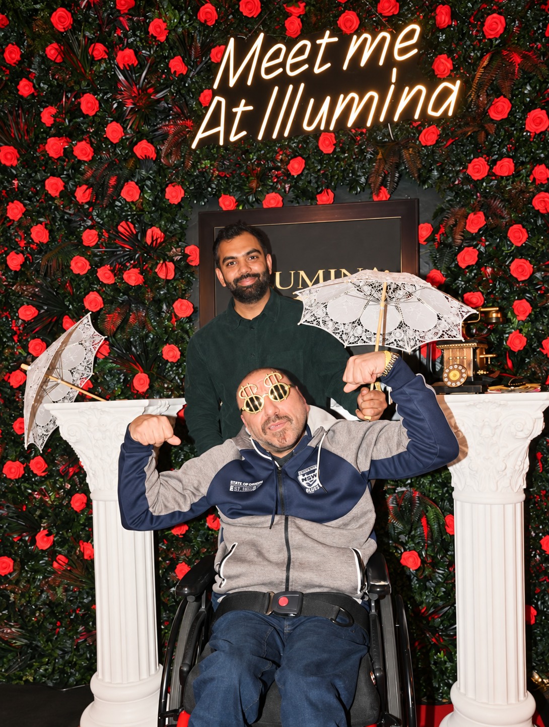 Two guests at Illumina's Meet me at Illumina rose wall